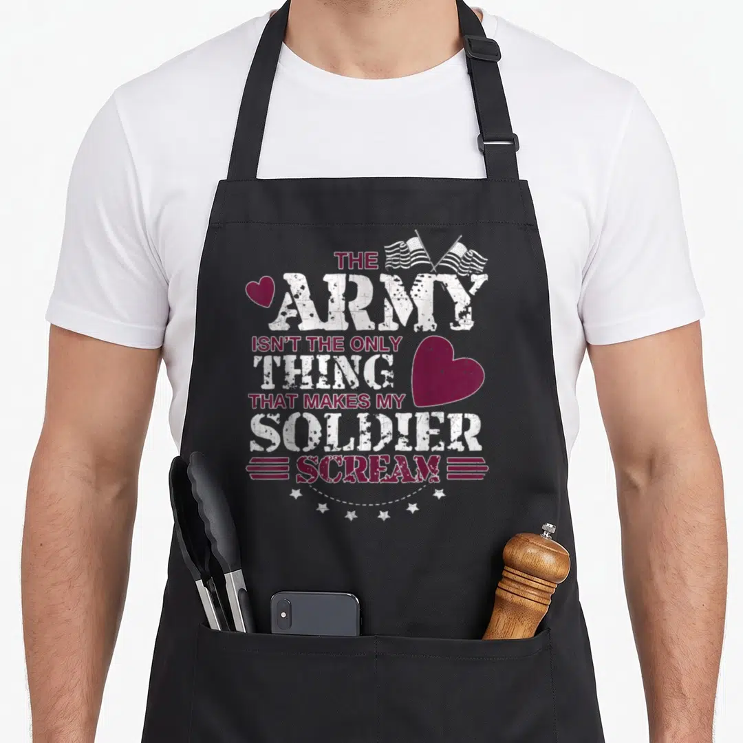 Scream wife apron - Stacked maroon and white text with two crossed flags, hearts, and six stars in distressed style — shown on a black cotton canvas apron against a white background