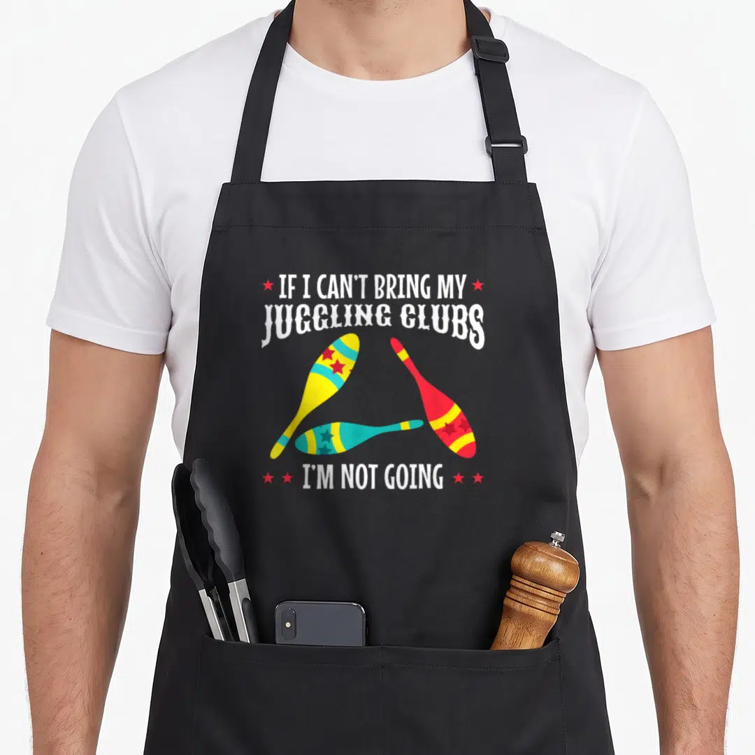 Act juggling life apron - Three juggling clubs in yellow blue and red with text IF I CAN'T BRING MY JUGGLING CLUBS I'M — shown on a black cotton canvas apron against a white background