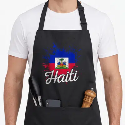 Haiti patriotic apron - Haiti flag rendered as blue red white paint splatter with white script text — shown on a black cotton canvas apron against a white background