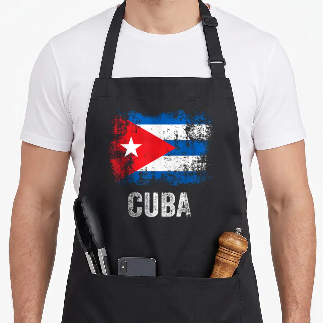 Funny cuba cuban apron - Distressed Cuban flag with white star and CUBA text on black background — shown on a black cotton canvas apron against a white background