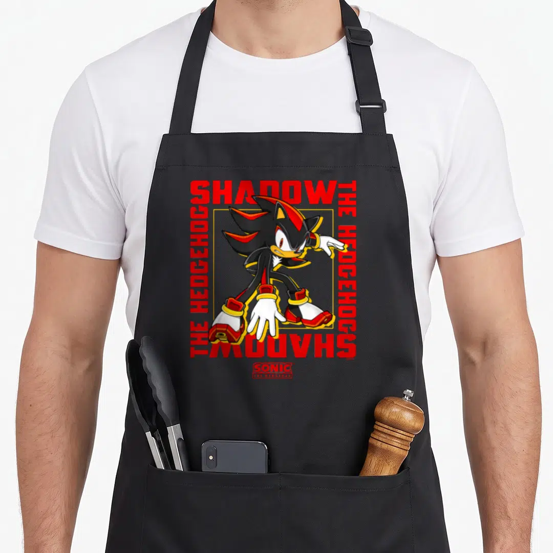 Epic crazy hedgehog man apron - Shadow the Hedgehog in yellow square surrounded by red text SHADOW THE HEDGEHOG — shown on a black cotton canvas apron against a white background