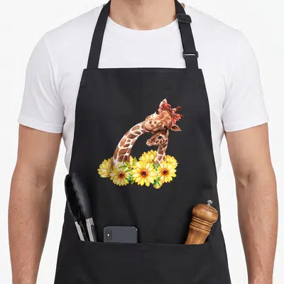 Sunflower giraffe apron - Two giraffes with red bandana and yellow sunflowers in watercolor style — shown on a black cotton canvas apron against a white background