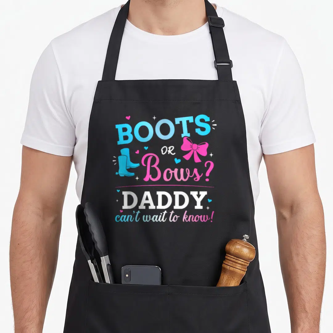 Boot bow apron - Stacked text BOOTS OR Bows? with blue boot and pink bow graphics — shown on a black cotton canvas apron against a white background