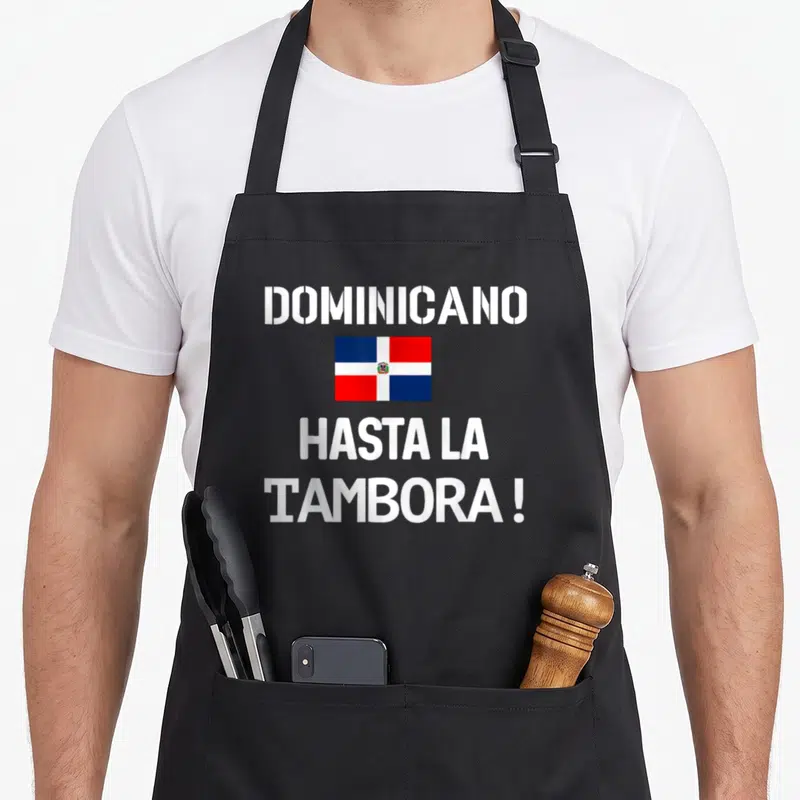 Dominicano pride apron - Dominican Republic flag with DOMINICANO and Hasta La Tambora text in white red and blue — shown on a black cotton canvas apron against a white background
