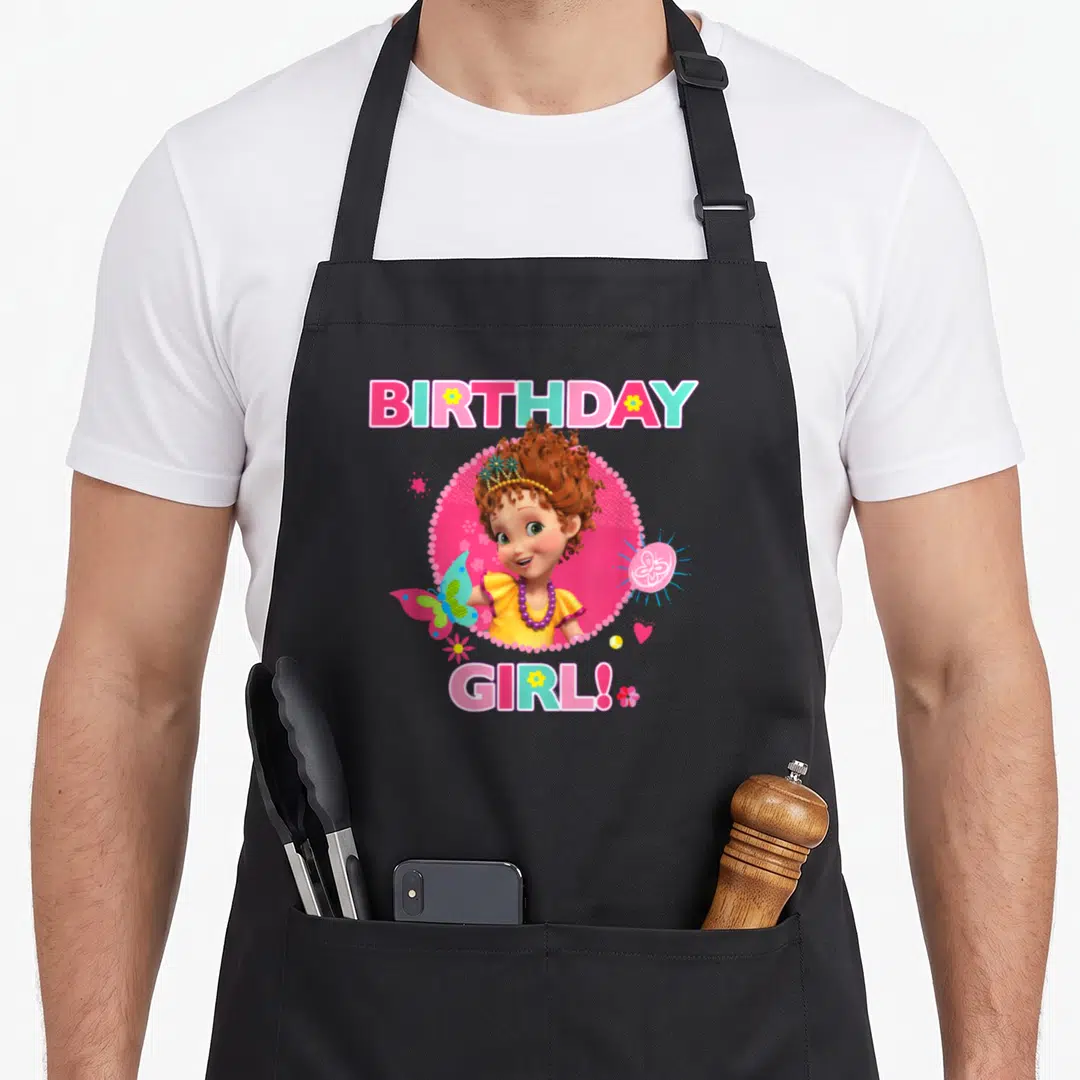 Fancy junior apron - Cartoon girl in pink dotted circle with BIRTHDAY GIRL text and butterfly — shown on a black cotton canvas apron against a white background