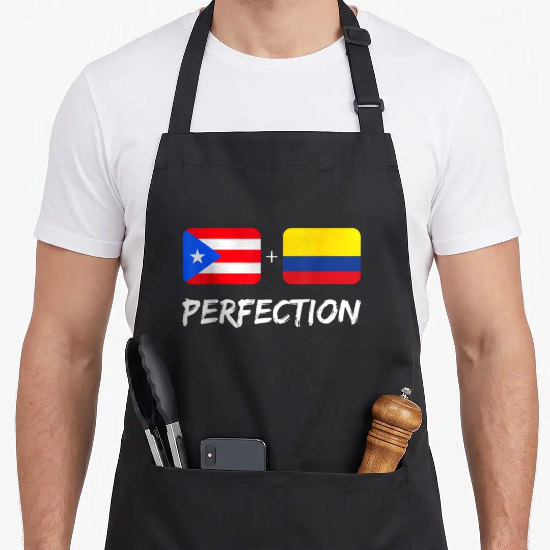 Perfection heritage aprons - Two flags connected by a plus sign above the word PERFECTION in red white blue and yellow — shown on a black cotton canvas apron against a white background
