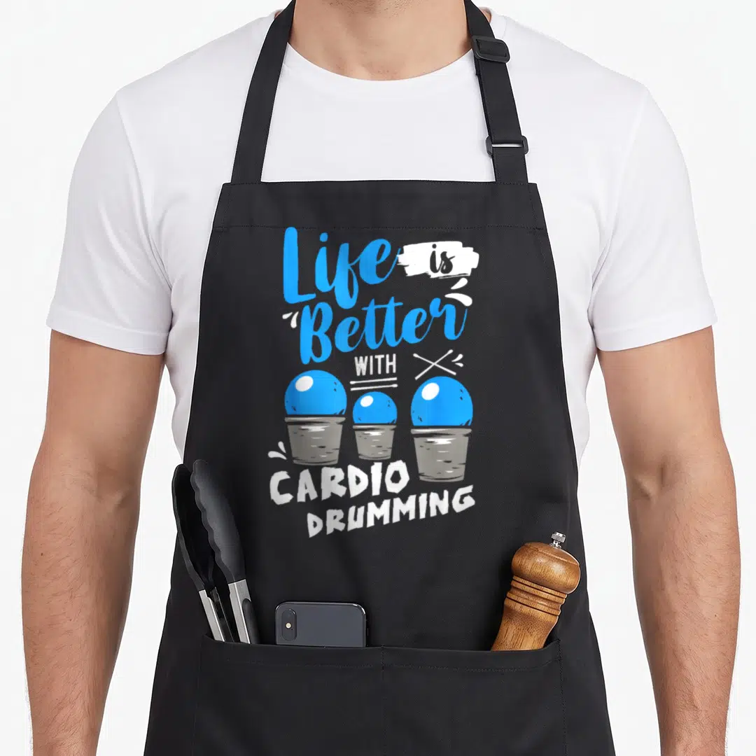 Better cardio apron - Stacked text Life is Better With Cardio Drumming above three blue balls in grey buckets — shown on a black cotton canvas apron against a white background