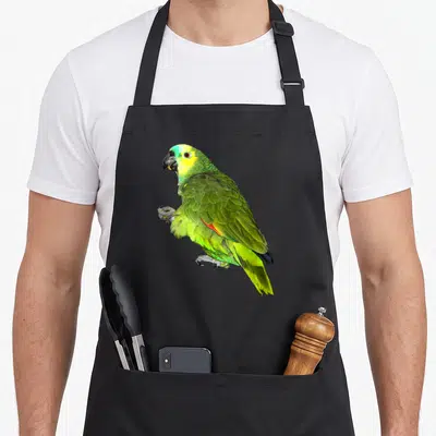 Attack parrot girl apron - Single green and yellow parrot photo centered on black fabric — shown on a black cotton canvas apron against a white background