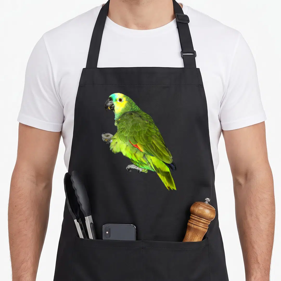 Attack parrot girl apron - Single green and yellow parrot photo centered on black fabric — shown on a black cotton canvas apron against a white background