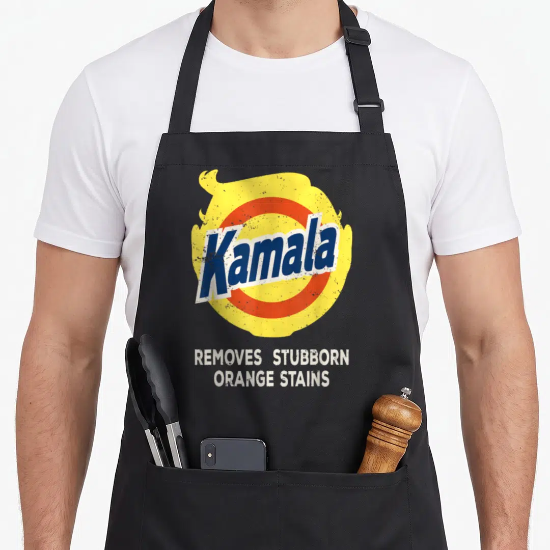 Kamala gorilla mom apron - Retro Kamala logo with yellow hair silhouette and text removes stubborn orange stains — shown on a black cotton canvas apron against a white background
