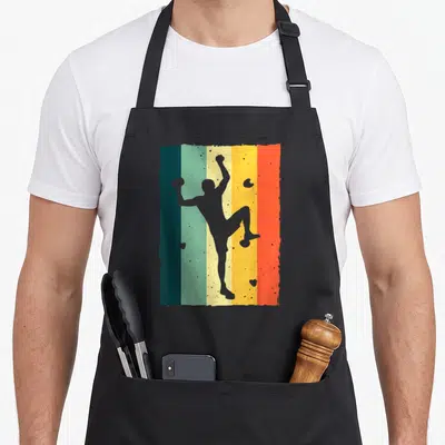 Cute rock bouldering apron - Grey climber silhouette on five vertical stripes of teal, yellow, orange, red, and grey — shown on a black cotton canvas apron against a white background