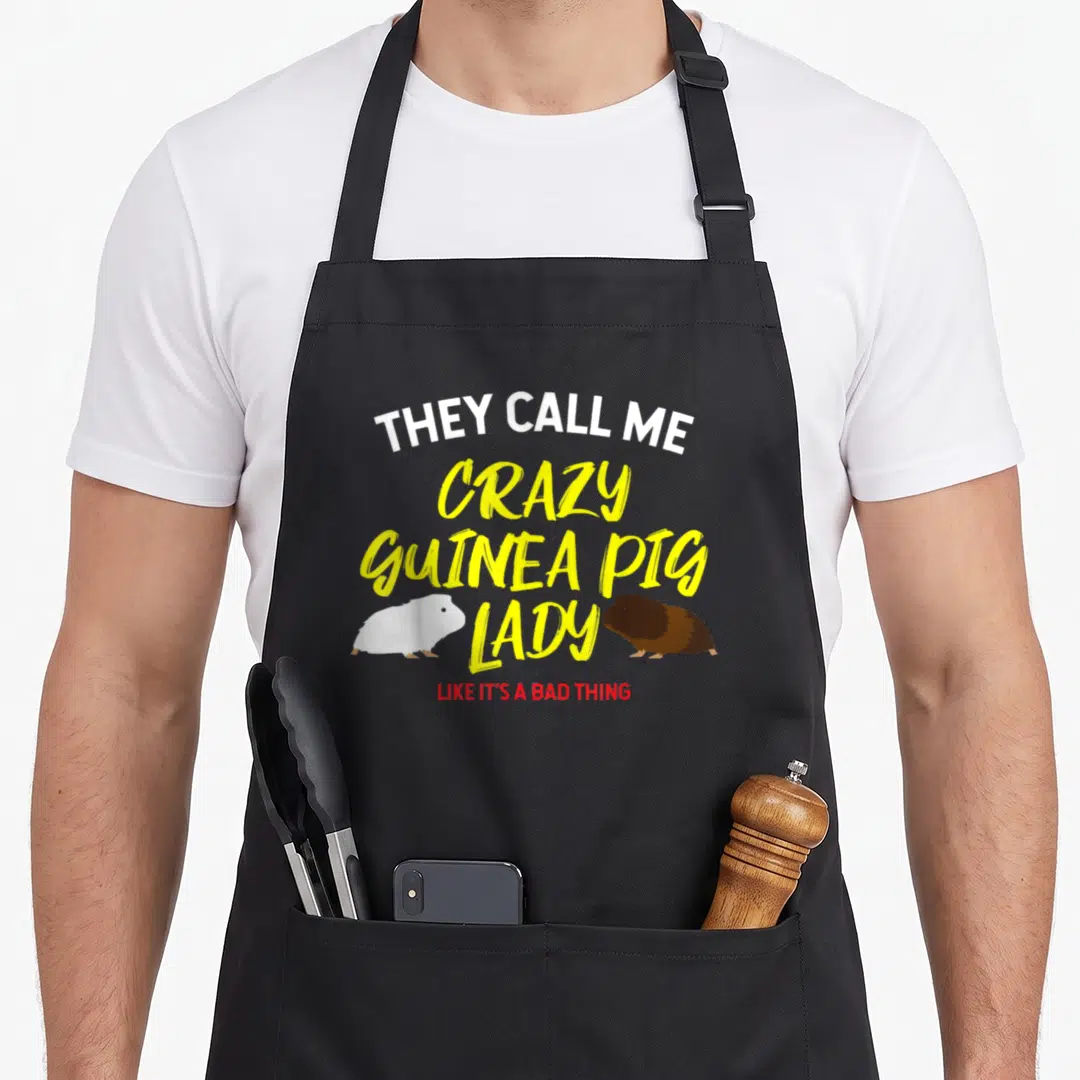 They crazy guinea lady apron - Stacked text they call me crazy guinea pig lady like its a bad thing with two rodent — shown on a black cotton canvas apron against a white background