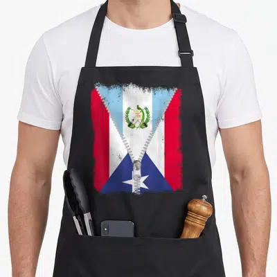 Rico guatemalan aprons - Flag unzipped to reveal coat of arms with LIBERTAD text in red, white, blue, and silver — shown on a black cotton canvas apron against a white background