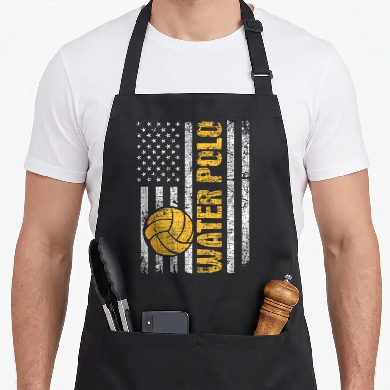 Flag water polo apron - Vertical US flag design with yellow water polo ball and distressed yellow lettering — shown on a black cotton canvas apron against a white background