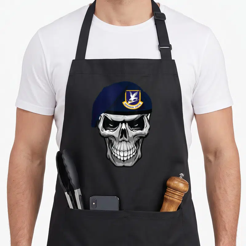 Air skull apron - Grey skull wearing navy beret with shield patch containing eagle and DEFENSOR FORTIS text — shown on a black cotton canvas apron against a white background