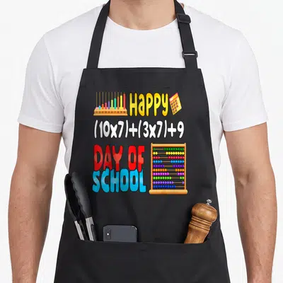 Formula school student teacher apron - Cartoon abacus and calculator with Happy 100 Day of School math equation — shown on a black cotton canvas apron against a white background