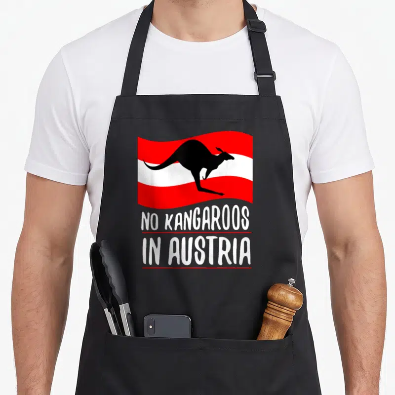 Funny austria kangaroo apron - Black kangaroo silhouette on red and white stripes with stacked white text separated — shown on a black cotton canvas apron against a white background
