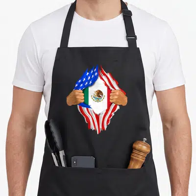 National mexican apron - Two hands rip USA flag revealing Mexican flag with eagle emblem — shown on a black cotton canvas apron against a white background