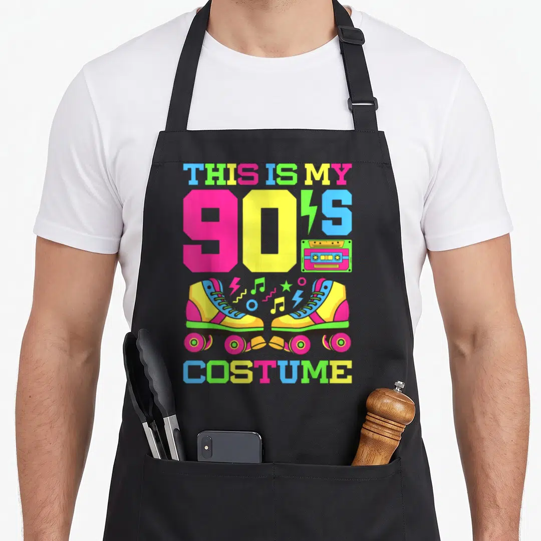 90s chef outfit apron - Two roller skates, cassette tape, and 'THIS IS MY 90'S COSTUME' text in neon pink yellow blue — shown on a black cotton canvas apron against a white background