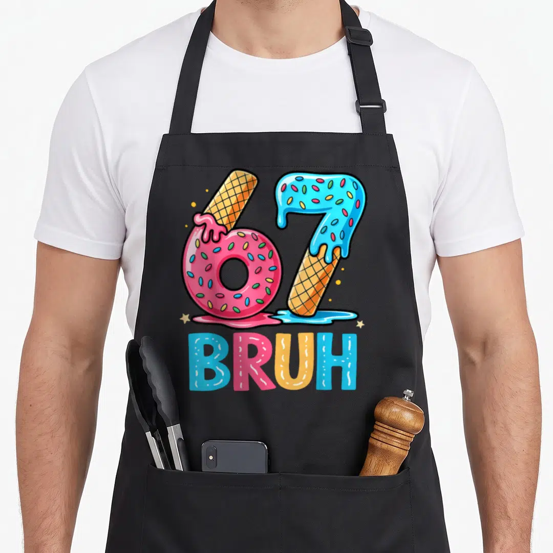 Six seven ice cream apron - Number 67 formed by pink donut and blue ice cream cone with BRUH text below — shown on a black cotton canvas apron against a white background