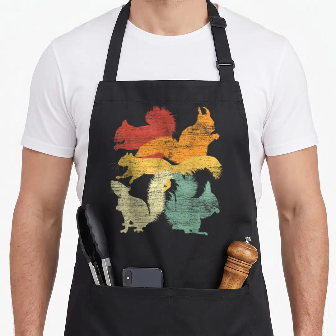 Forest squirrel aprons - Four stacked squirrel silhouettes in red orange yellow and green with distressed texture — shown on a black cotton canvas apron against a white background