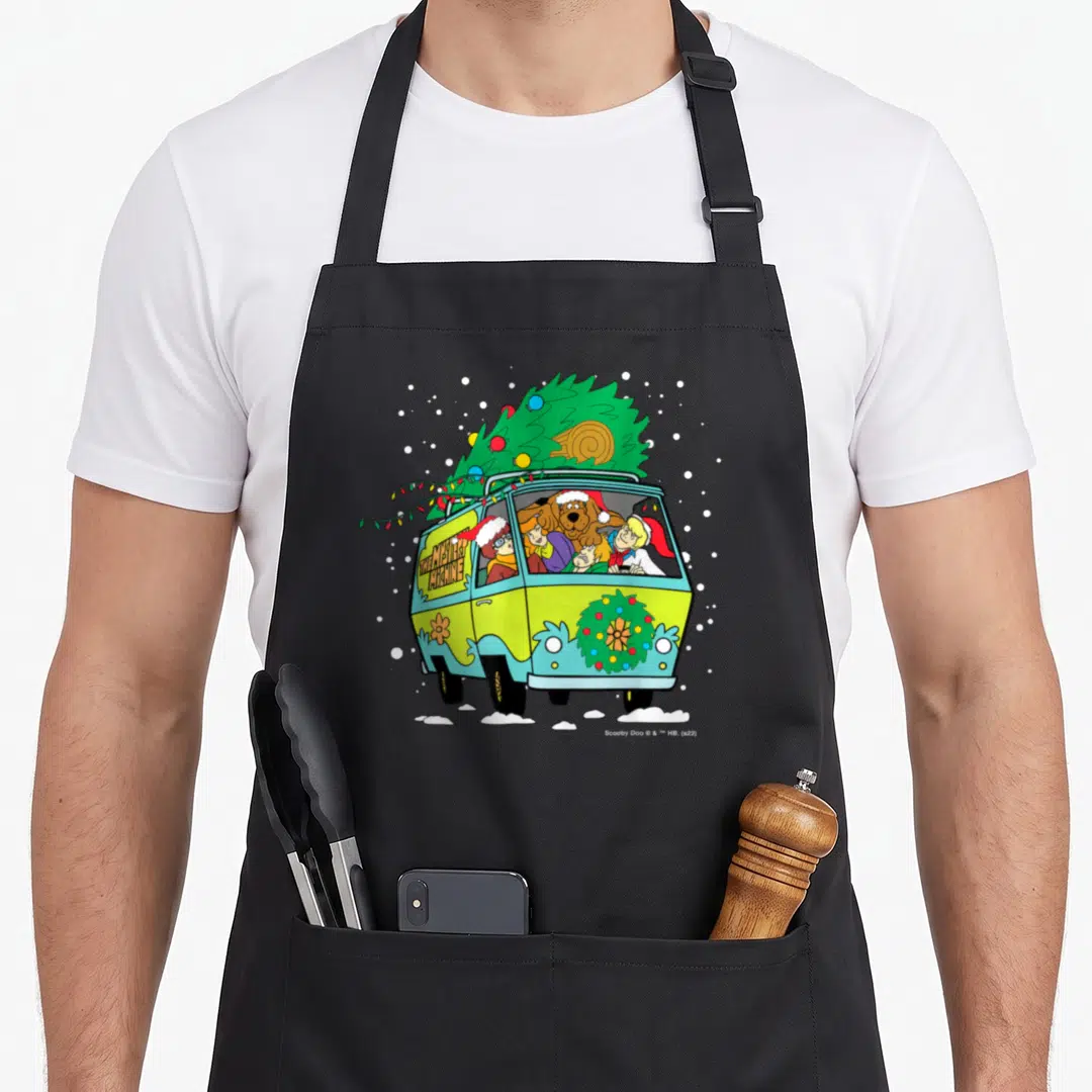 Mystery christmas apron - Mystery Machine van front view with Christmas tree, Santa hats, THE MYSTERY MACHINE text — shown on a black cotton canvas apron against a white background