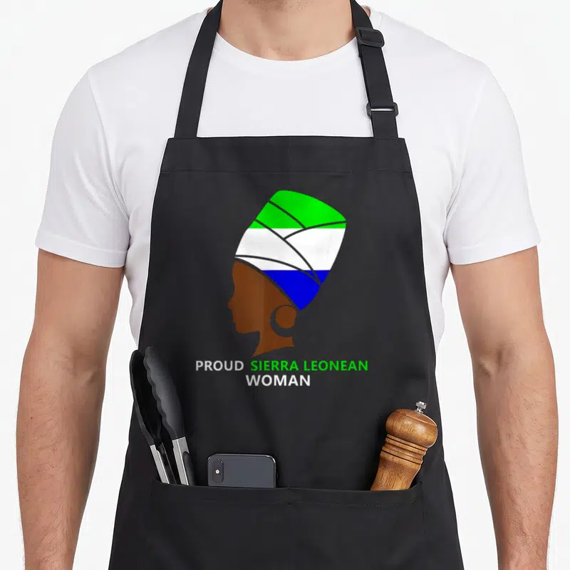 Sierra african apron - Brown woman silhouette wearing green white and blue headwrap with text below — shown on a black cotton canvas apron against a white background