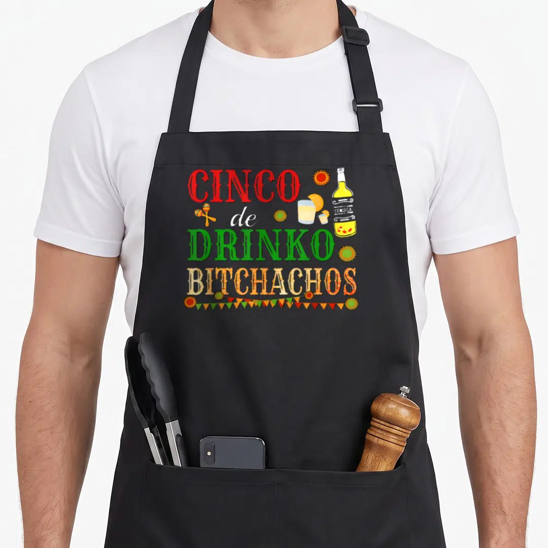 Cinco burritos apron - Stacked red green and orange text with tequila bottle maraca and bunting — shown on a black cotton canvas apron against a white background