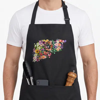 Liver floral apron - Watercolor liver silhouette filled with pink, yellow, green, and orange flowers — shown on a black cotton canvas apron against a white background