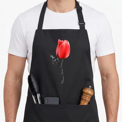 Disease tulip apron - Red tulip with Parkinson's Disease Awareness text stem and white ribbons — shown on a black cotton canvas apron against a white background