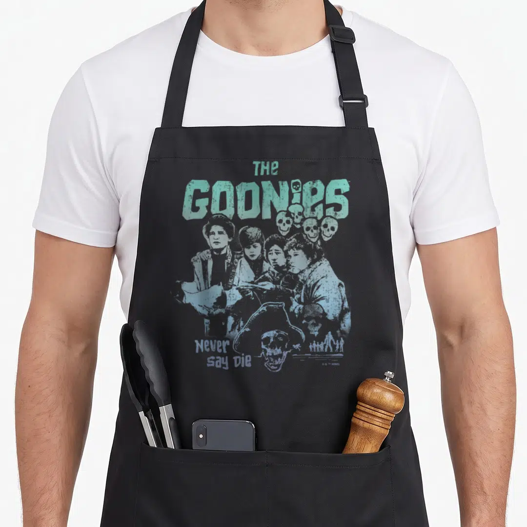 Funny die novelty apron - The Goonies children and skulls in distressed light blue and grey print — shown on a black cotton canvas apron against a white background