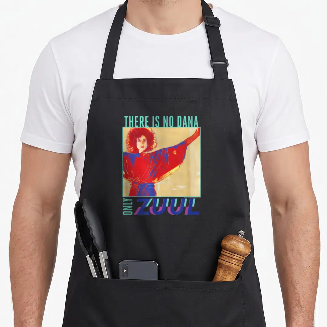 Dana pop art apron - Retro graphic with text There Is No Dana Only Zuul surrounding a framed woman in red and blue — shown on a black cotton canvas apron against a white background