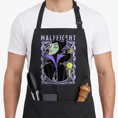 School beauty apron - Maleficent character and raven in distressed purple ornate border with printed name — shown on a black cotton canvas apron against a white background