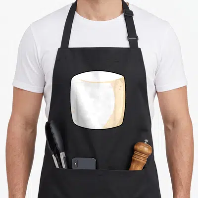 Marshmallow smore halloween apron - Cartoon marshmallow in white beige and black centered on apron front — shown on a black cotton canvas apron against a white background