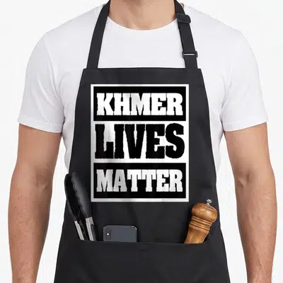 Khmer cambodian girl apron - Stacked black and white text blocks reading KHMER LIVES MATTER — shown on a black cotton canvas apron against a white background