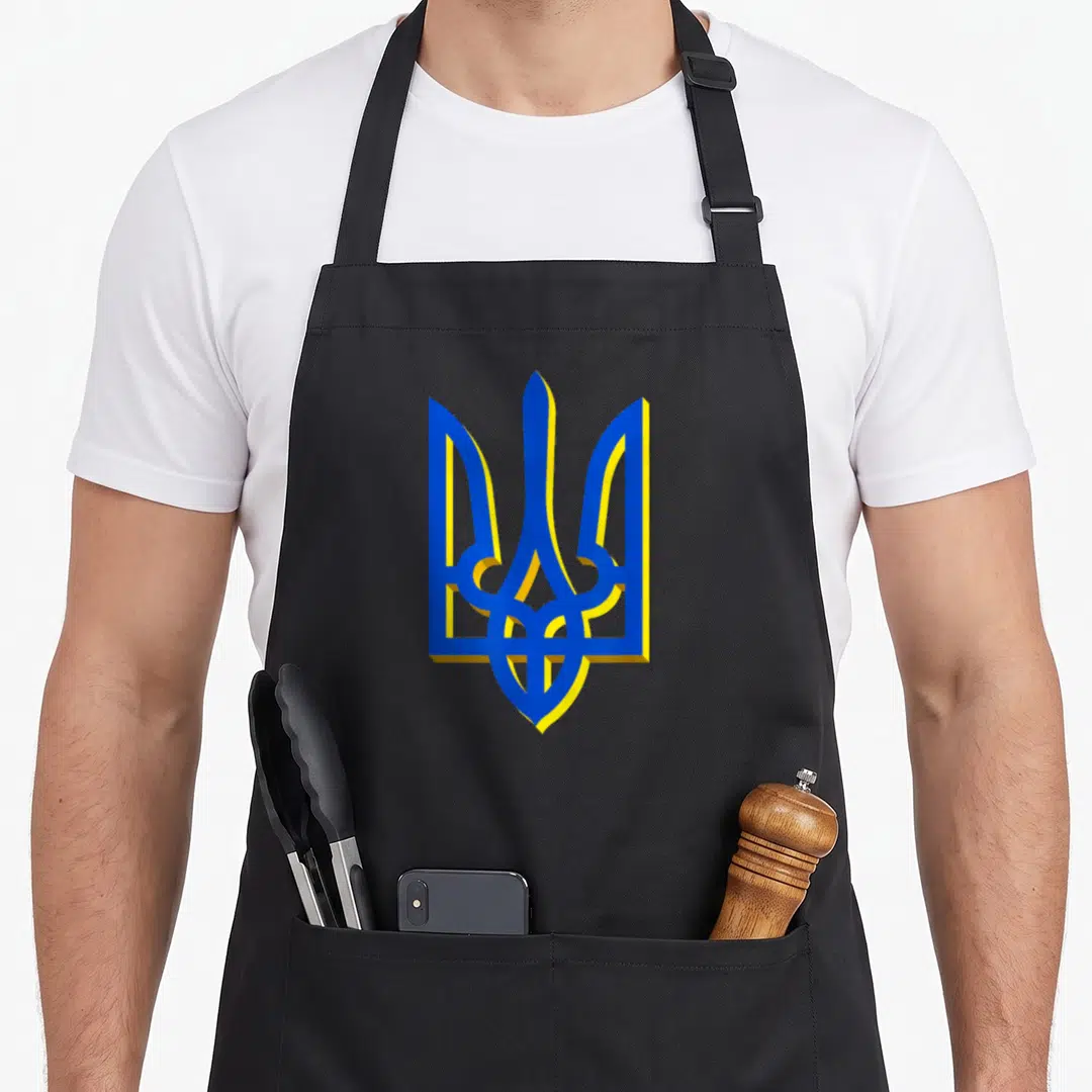 Coat arm ukrainian aprons - Blue and yellow 3D tryzub emblem centered on black background — shown on a black cotton canvas apron against a white background