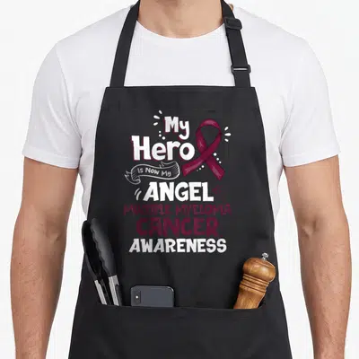 Mein myeloma awareness apron - Maroon ribbon and stacked white text reading My Hero Is Now My Angel Multiple Myeloma — shown on a black cotton canvas apron against a white background