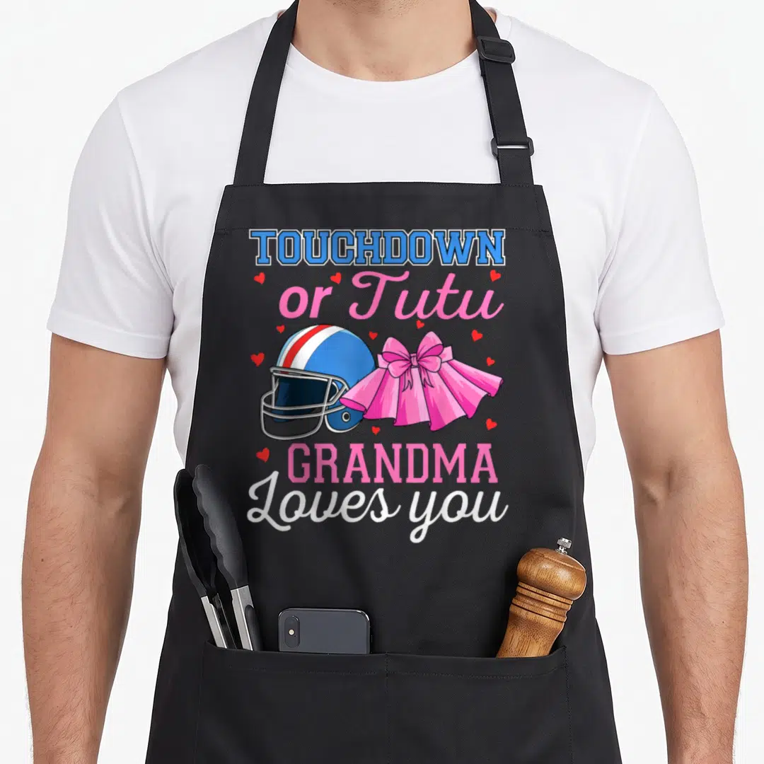 Touchdown grandma aprons - Blue football helmet and pink tutu with red hearts and stacked text — shown on a black cotton canvas apron against a white background