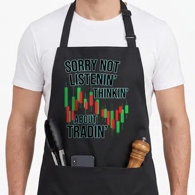 Trading market stock aprons - Stacked text SORRY NOT LISTENIN' THINKIN' ABOUT TRADIN' over red and green candlesticks — shown on a black cotton canvas apron against a white background