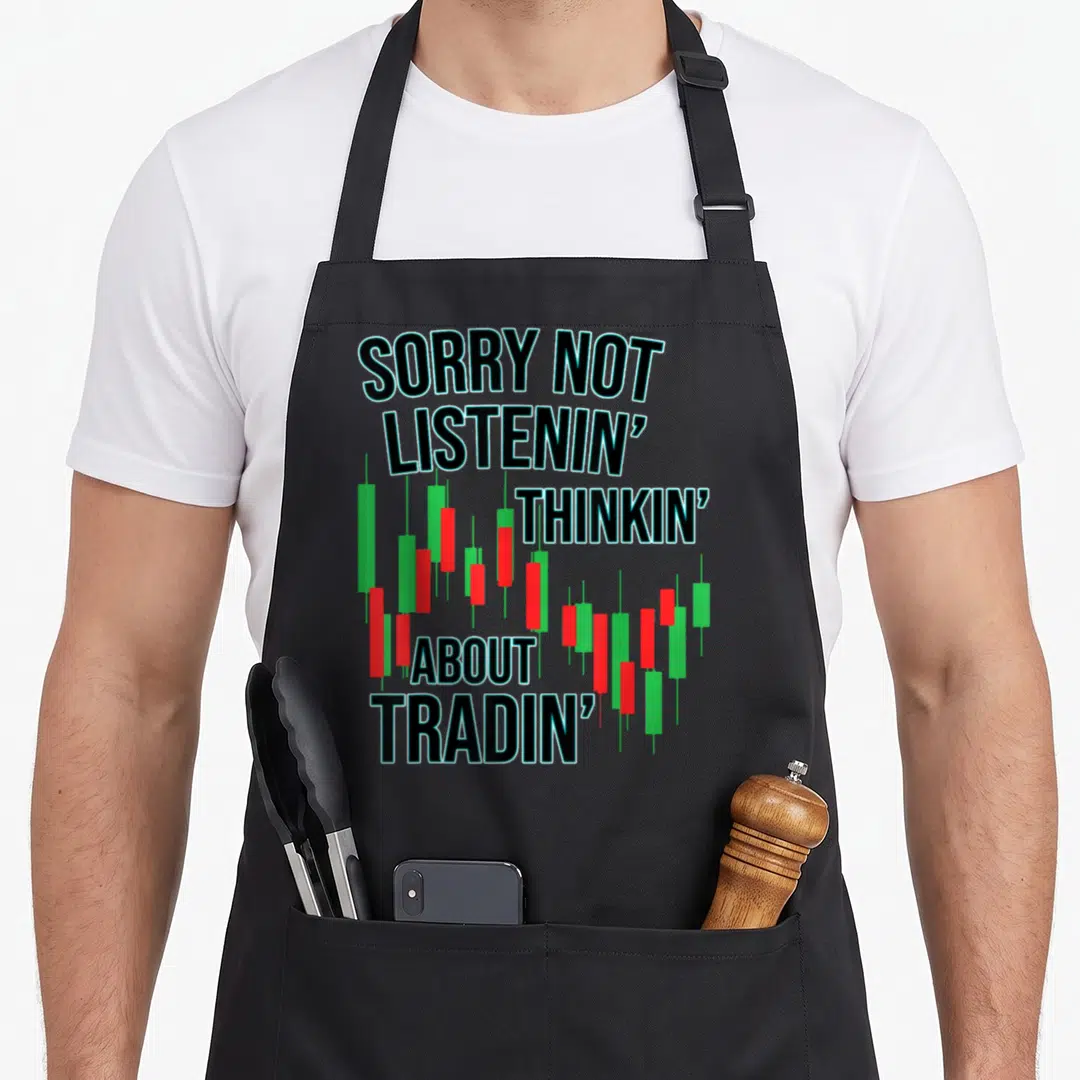 Trading market stock aprons - Stacked text SORRY NOT LISTENIN' THINKIN' ABOUT TRADIN' over red and green candlesticks — shown on a black cotton canvas apron against a white background