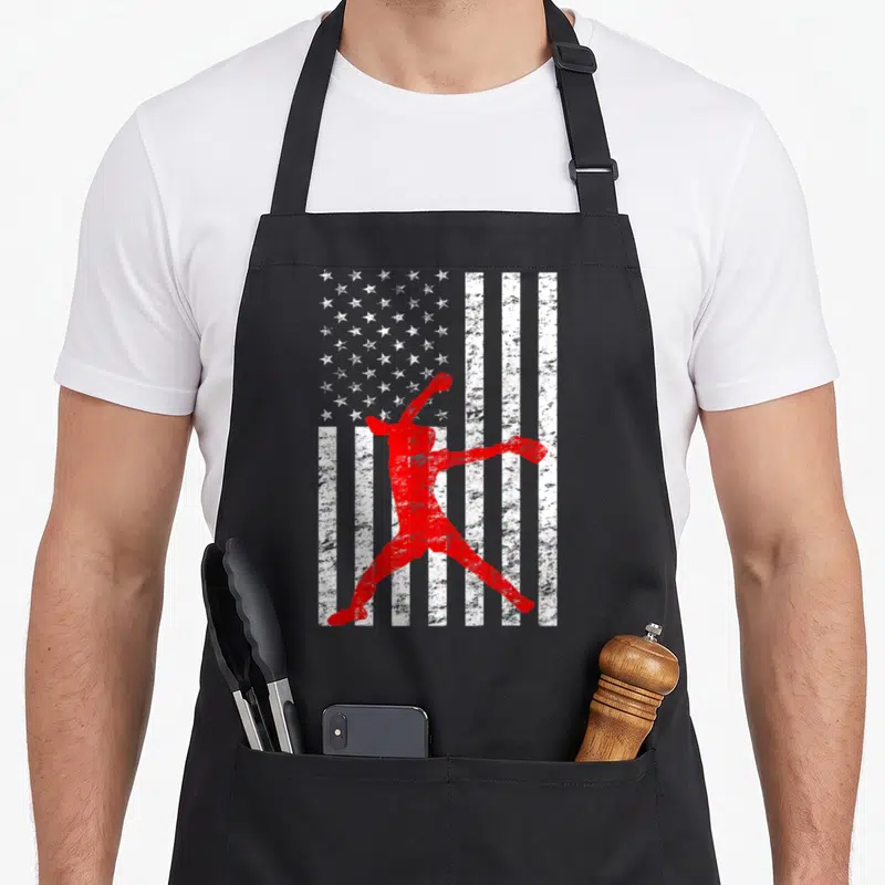 Fastpitch american flag apron - Red pitcher silhouette over distressed white stars and stripes pattern — shown on a black cotton canvas apron against a white background