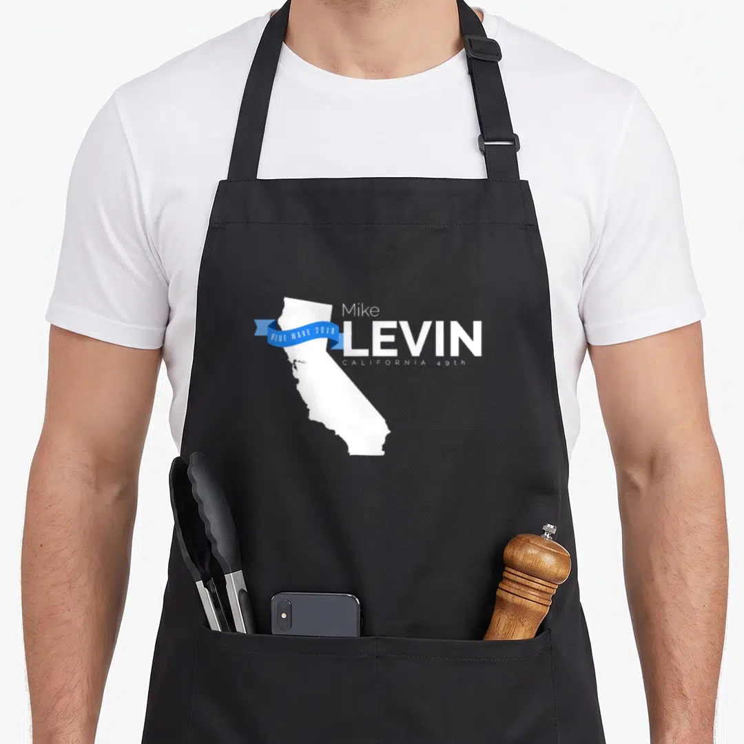 Mike midterms apron - White California map silhouette with blue ribbon reading Blue Wave 2018 next to stacked Mike — shown on a black cotton canvas apron against a white background
