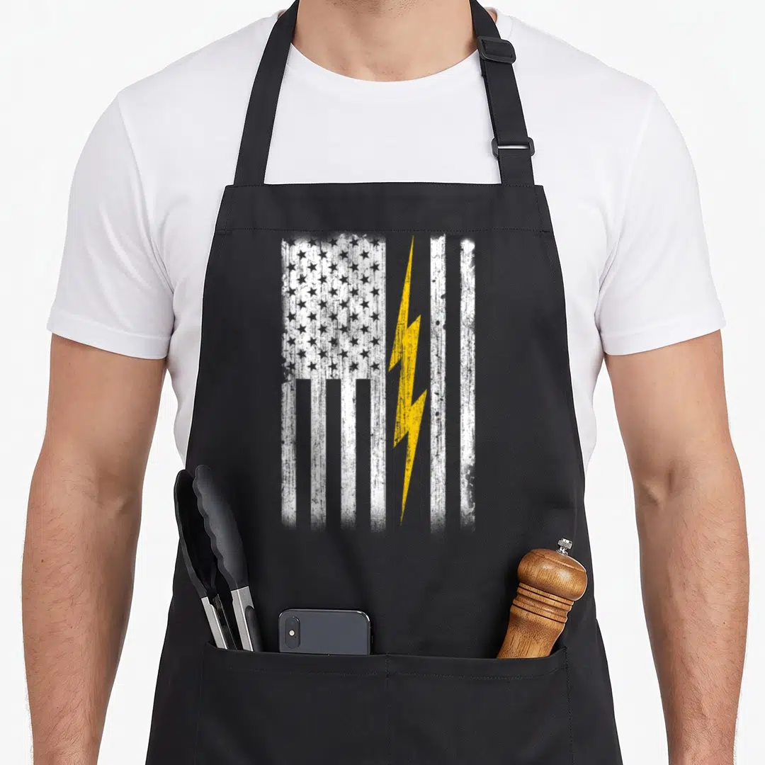 Funny flag electrician apron - Distressed white flag with yellow lightning bolt overlay on right side stripes — shown on a black cotton canvas apron against a white background