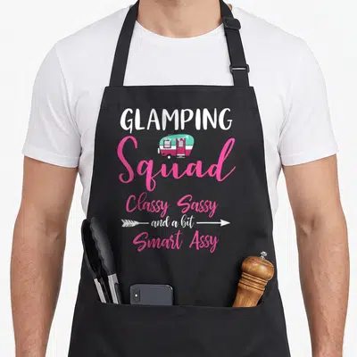 Glamping family aprons - Stacked text camper van in pink white teal with arrows — shown on a black cotton canvas apron against a white background
