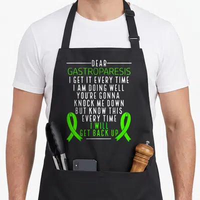Funny gastroparesis ribbon apron - White and lime green text reading Dear Gastroparesis flanked by two awareness ribbons — shown on a black cotton canvas apron against a white background