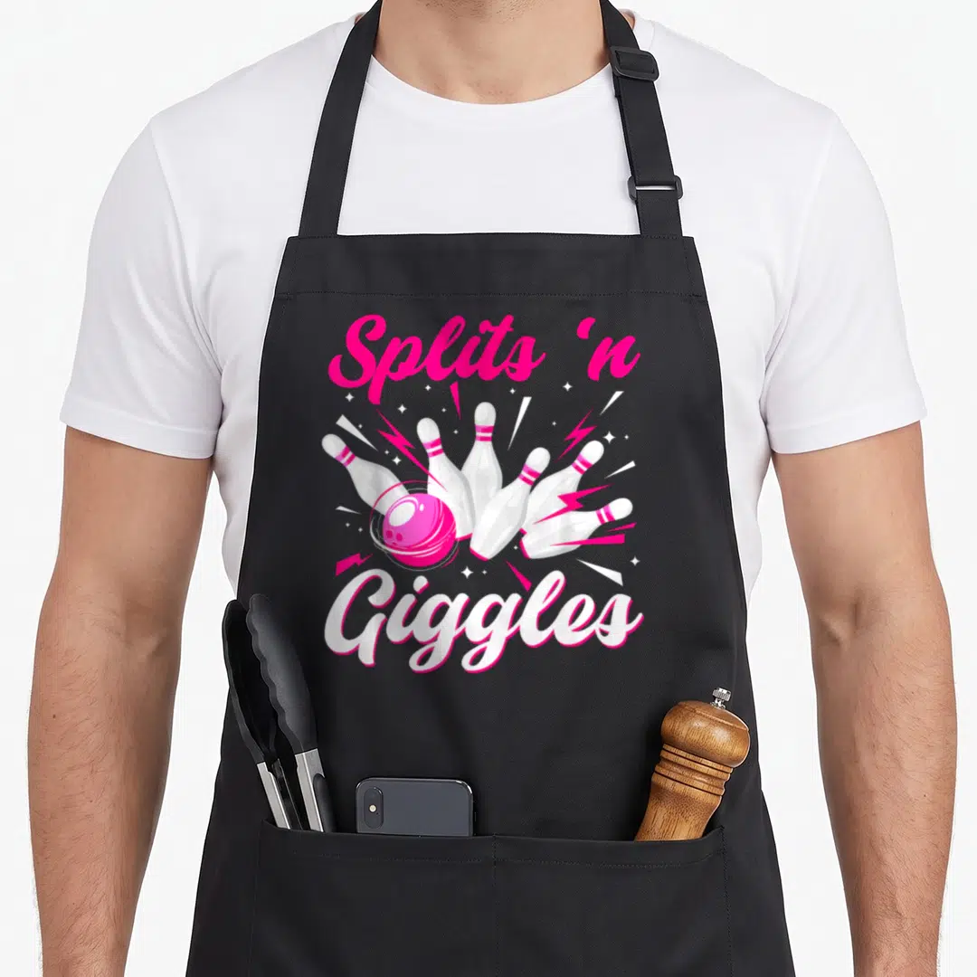 Giggle split apron - Pink bowling ball hitting white pins with Splits 'n Giggles text and lightning bolts — shown on a black cotton canvas apron against a white background