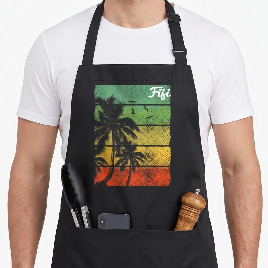 Tropical fiji apron - Retro sunset apron with green yellow orange red bands, palm trees, birds, and white Fifi text — shown on a black cotton canvas apron against a white background