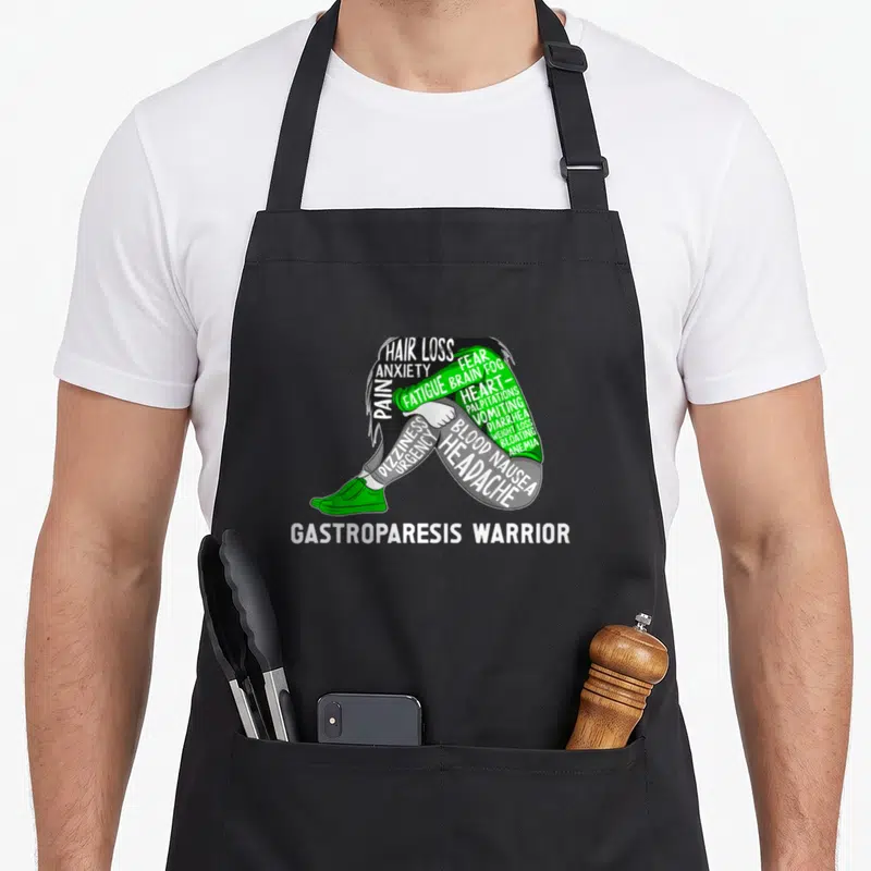 Month gastroparesis awareness apron - Person formed by symptom words Hair Loss Pain Fatigue Brain Fog in green white — shown on a black cotton canvas apron against a white background