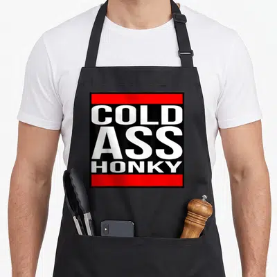 Honky funny cold apron - White COLD ASS HONKY text between two red bars on black background — shown on a black cotton canvas apron against a white background