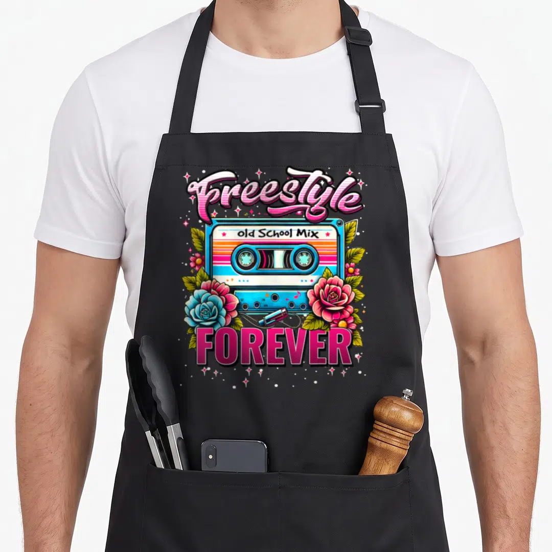 Perfect 80s apron - Retro cassette tape with Freestyle Old School Mix text and pink blue roses — shown on a black cotton canvas apron against a white background